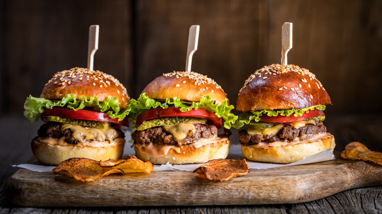 cheeseburgers on a wooden board