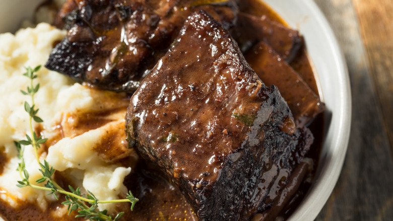 Braised ribs in a bowl of mashed potatoes