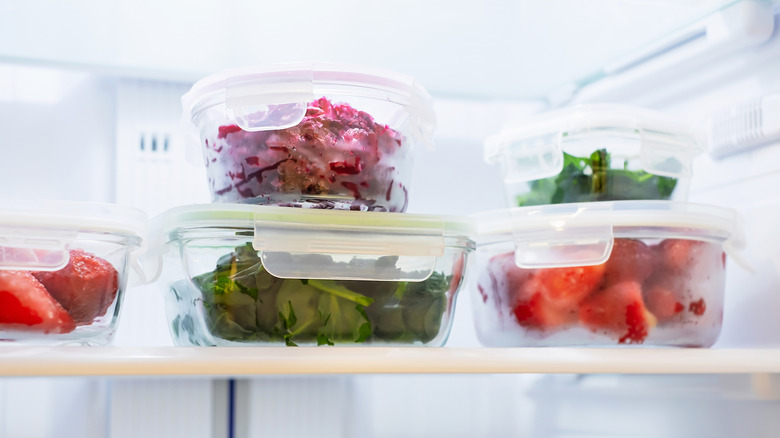 Glass containers with leftover food in freezer.