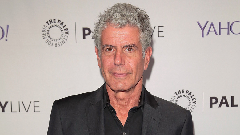 Anthony Bourdain poses at event