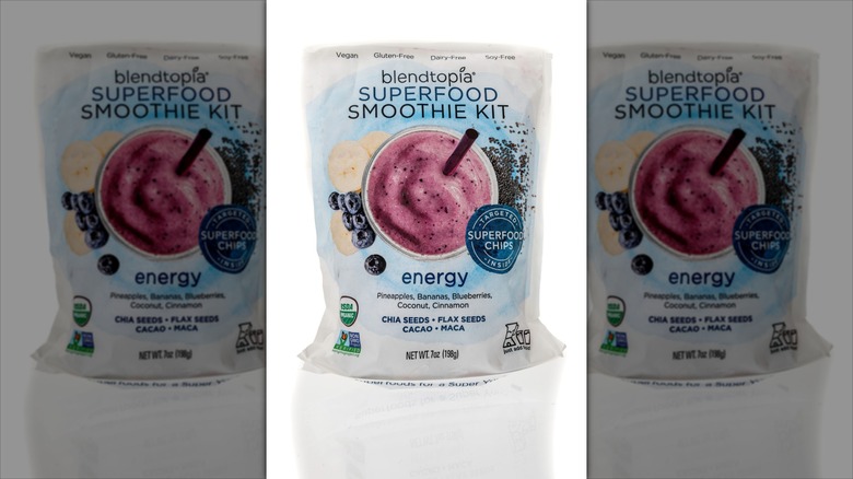 A photo of the product package for the Blendtopia Energy Superfood Smoothie Kit against a mirrored backdrop