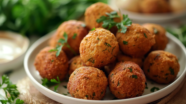 A plate of golden brown falafel balls.