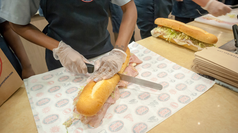 Sub being cut in half at Jersey Mike's