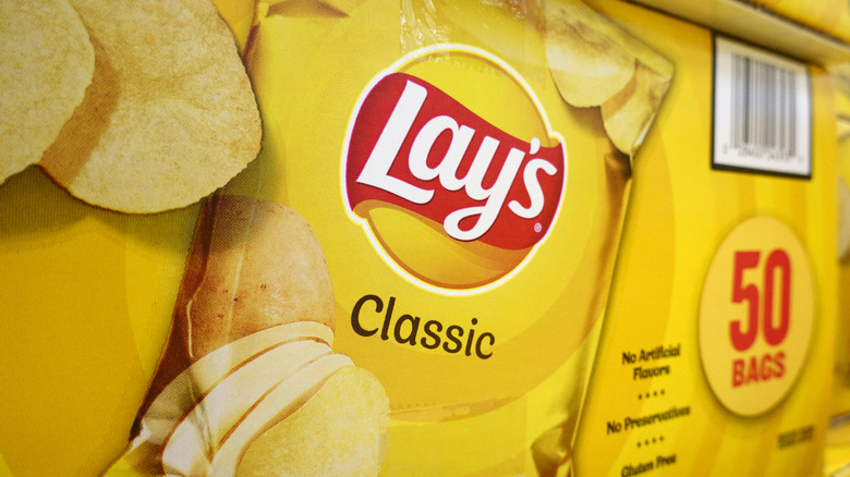 Closeup of a box of 50 bags of Lay's Classic potato chips
