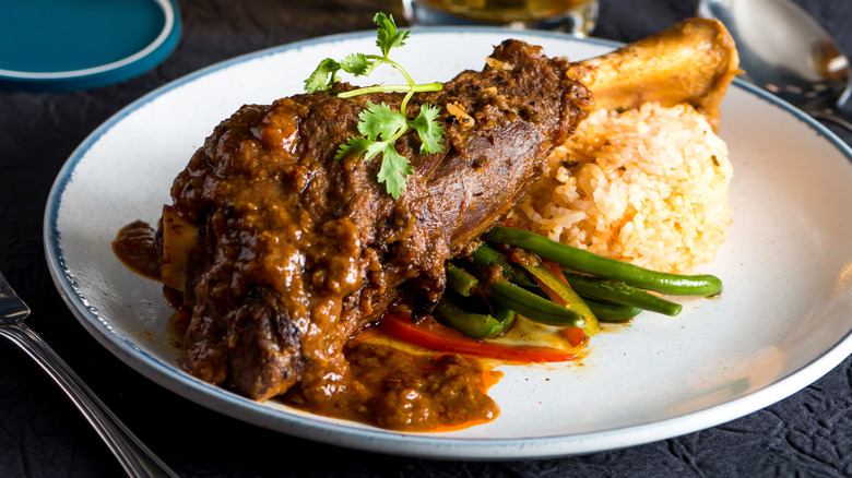 Curried lamb shank with rice and vegetables