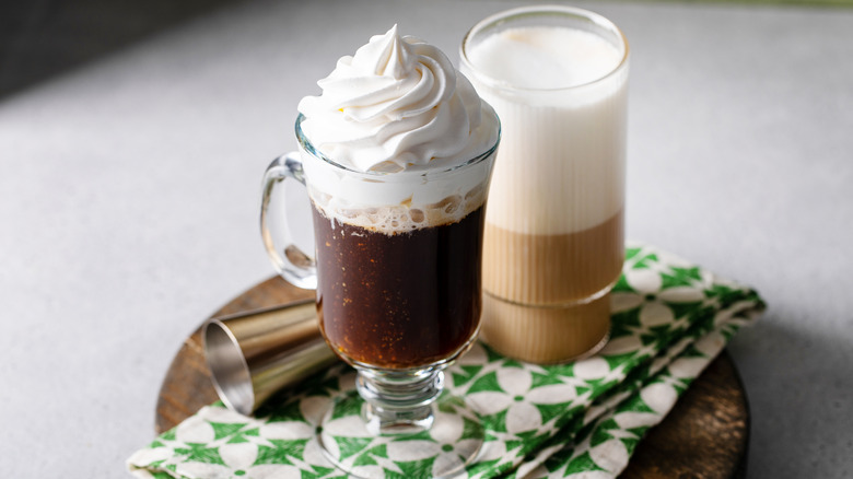 Two coffee cocktails made with Irish cream liqueur, on a white and green cloth