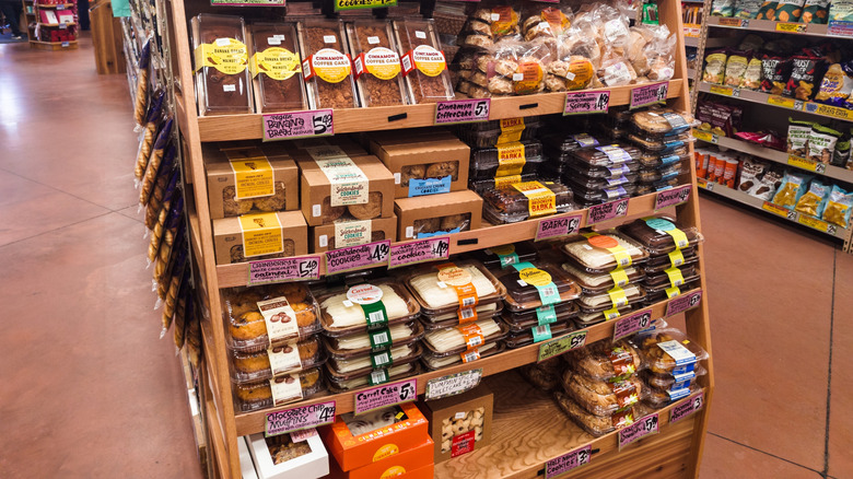 A bakery shelf at Trader Joe's featuring assorted cakes and other desserts