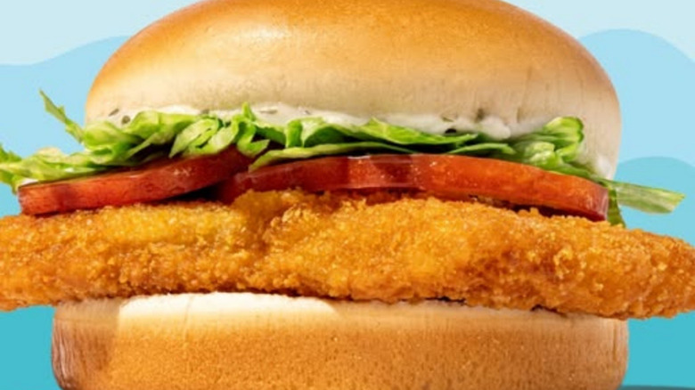 Close-up of Whataburger's Whatacatch sandwich with blue background