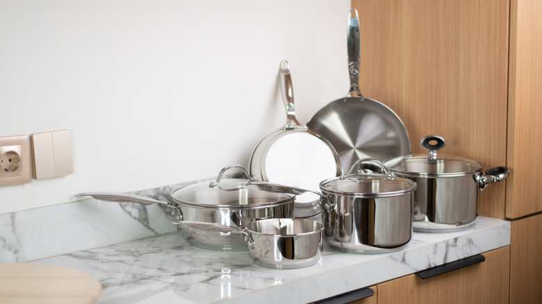 Stainless steel pots and pans on a countertop