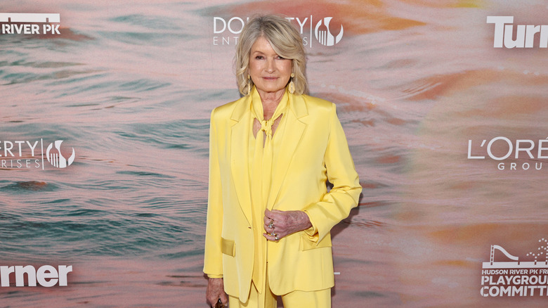 Martha Stewart in front of a backdrop at an event
