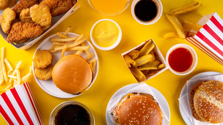 A spread of assorted fast food items on a yellow background