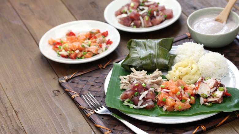 A table with plates of Hawaiian dishes