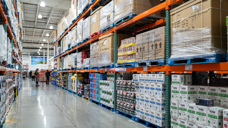 An aisle inside Costco with shoppers in the back