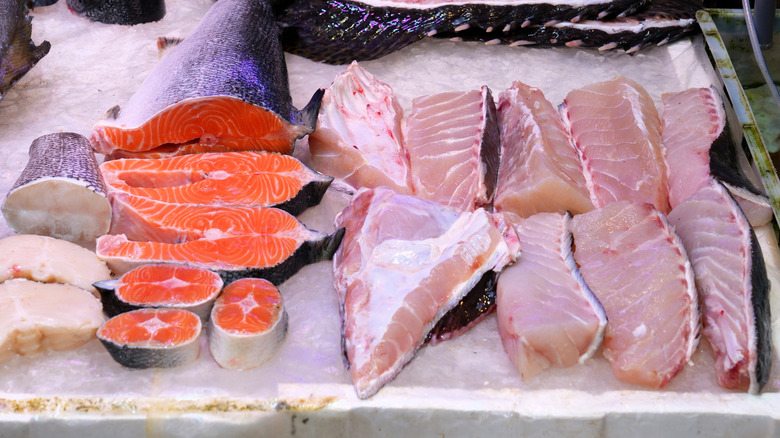 An assortment of fresh fish on ice at a fish market