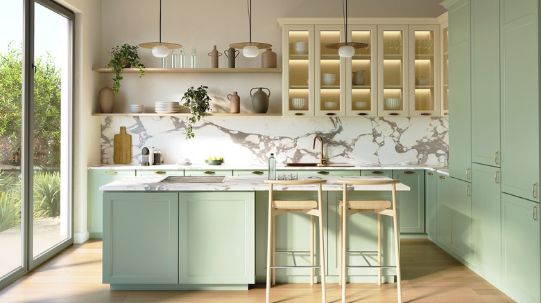 Green kitchen with island and overhead lights